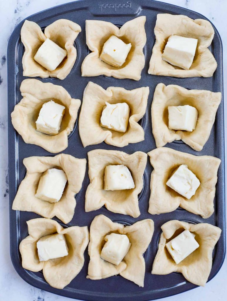 cheese in tin pan over crescent dough