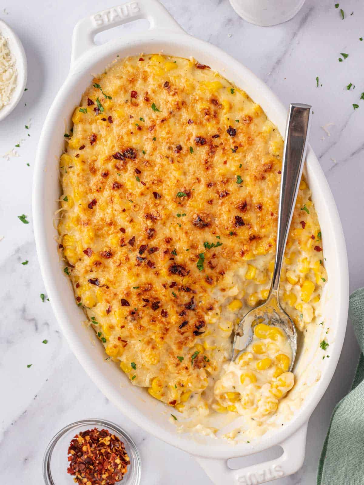 creamed corn casserole dish with a spoon in it
