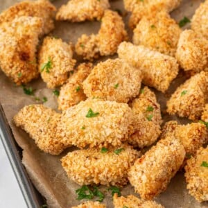 Crispy popcorn chicken on a baking sheet.