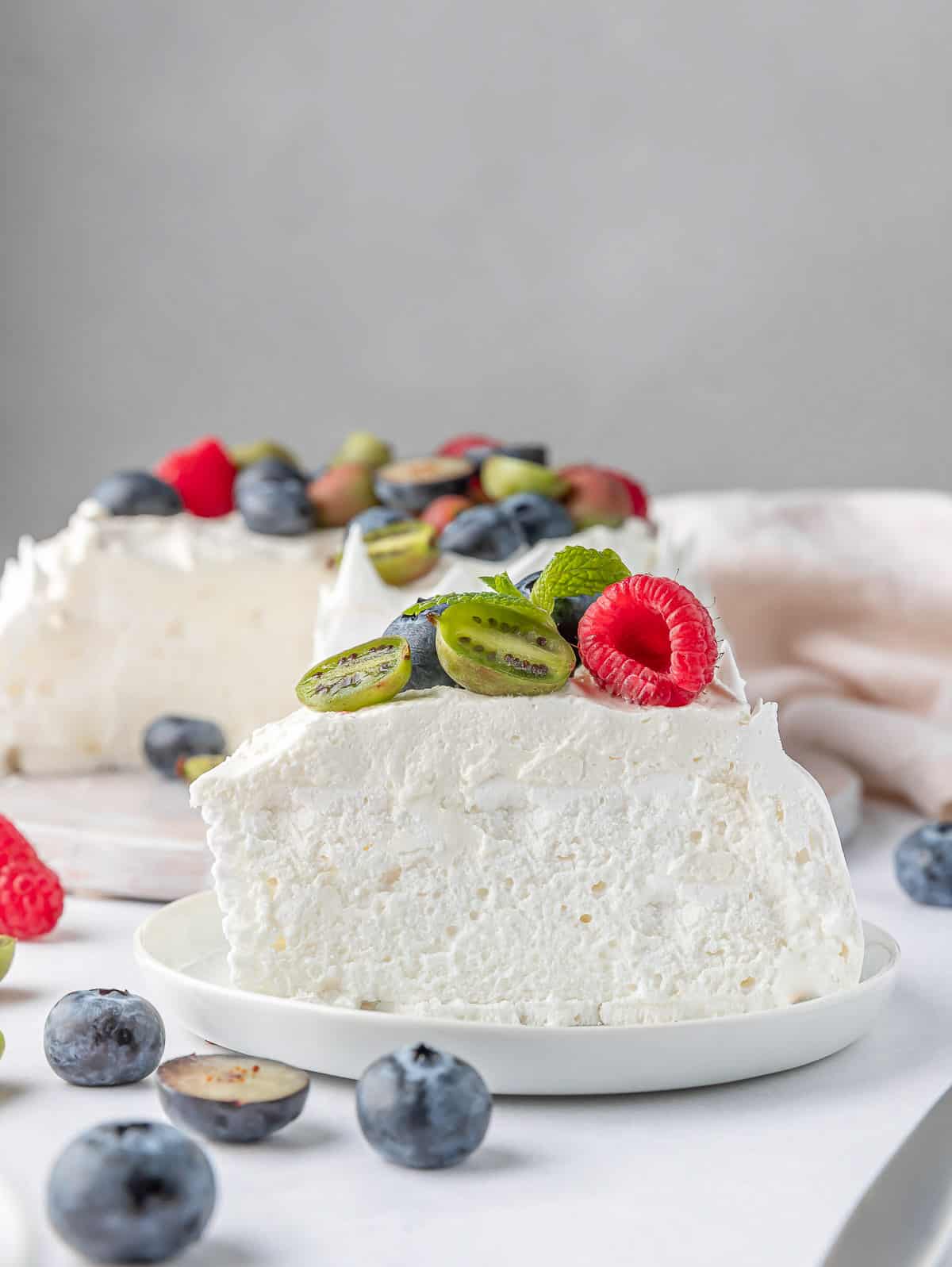 slice of berry pavlova cake on a white plate