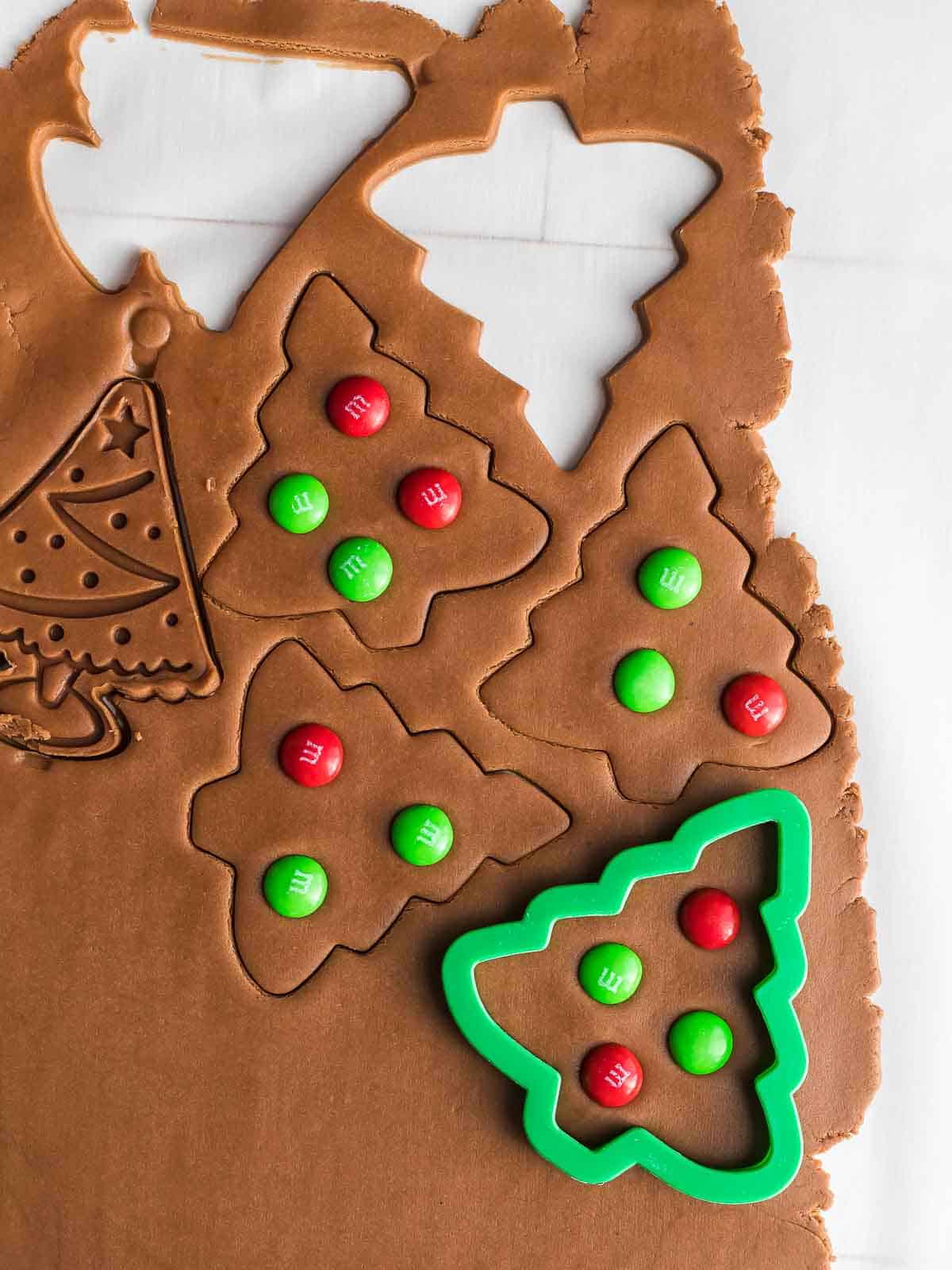 tree cookies being cut with cookie cutter