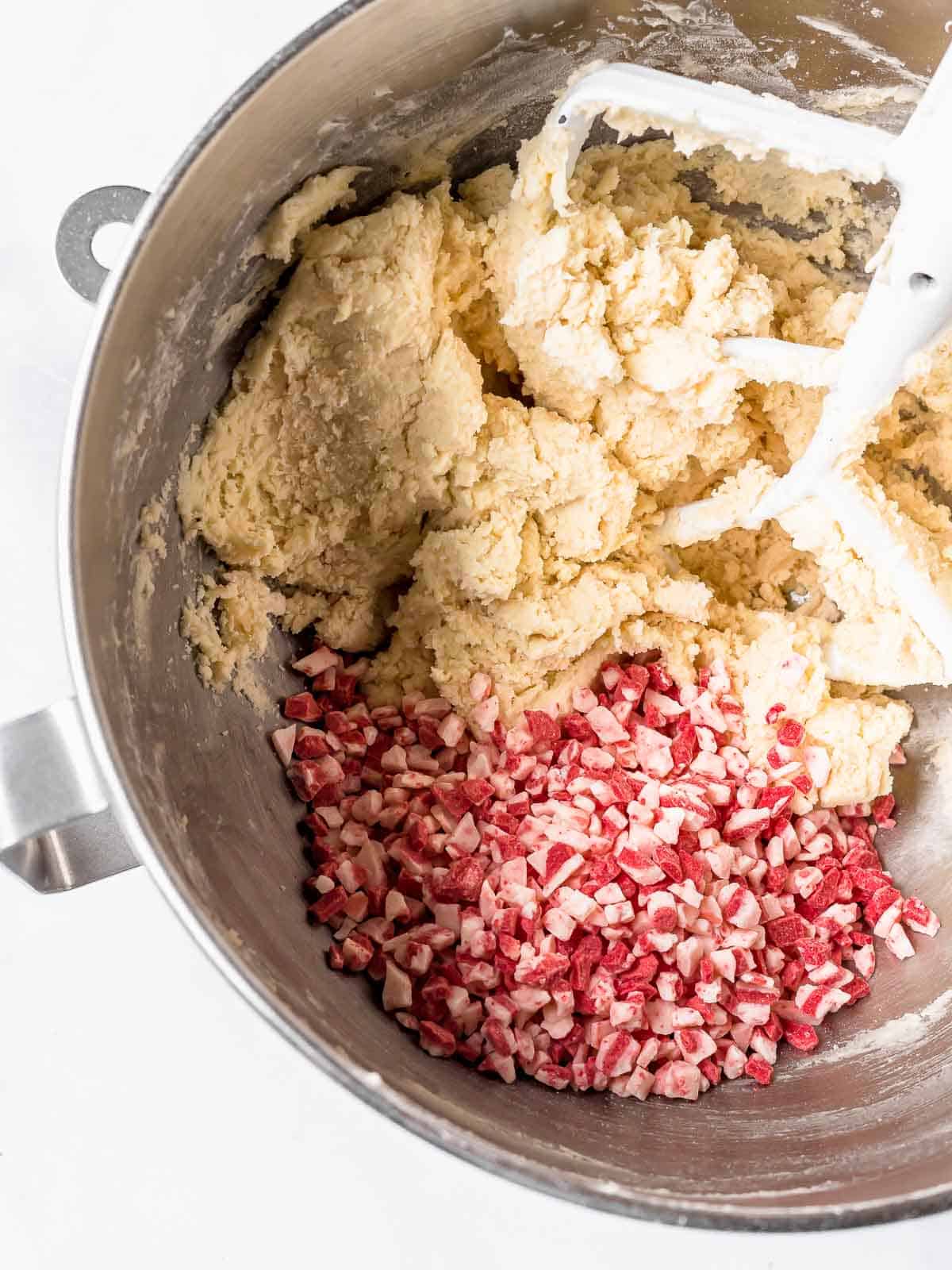 dough and peppermint chips in a mixing bowl