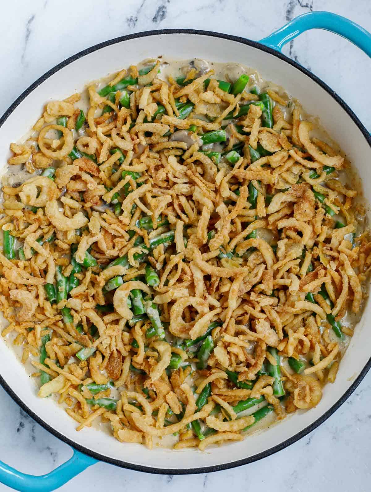 green been casserole topped with fried onions before baking