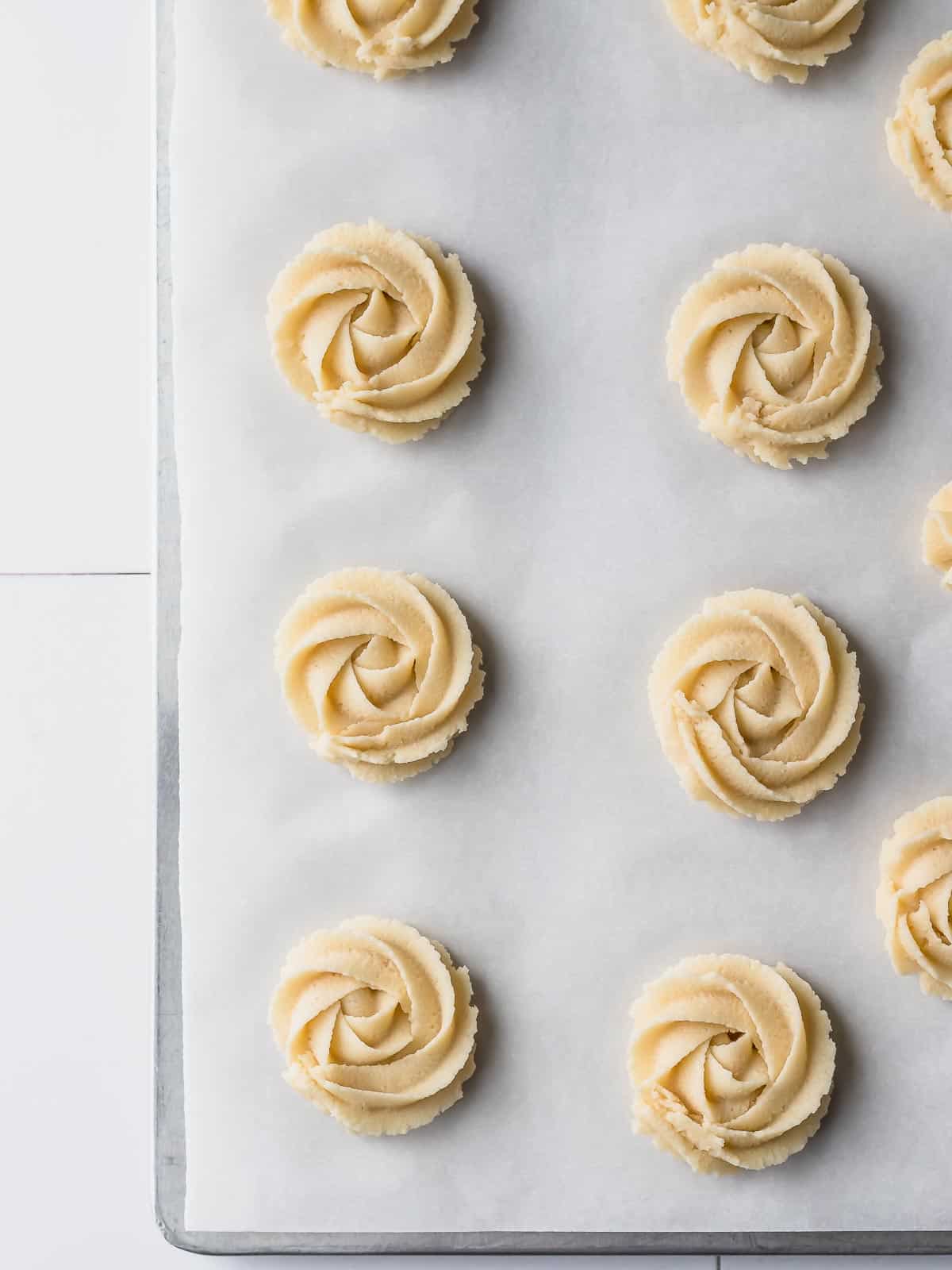 uncooked danish cookies piped in a pan