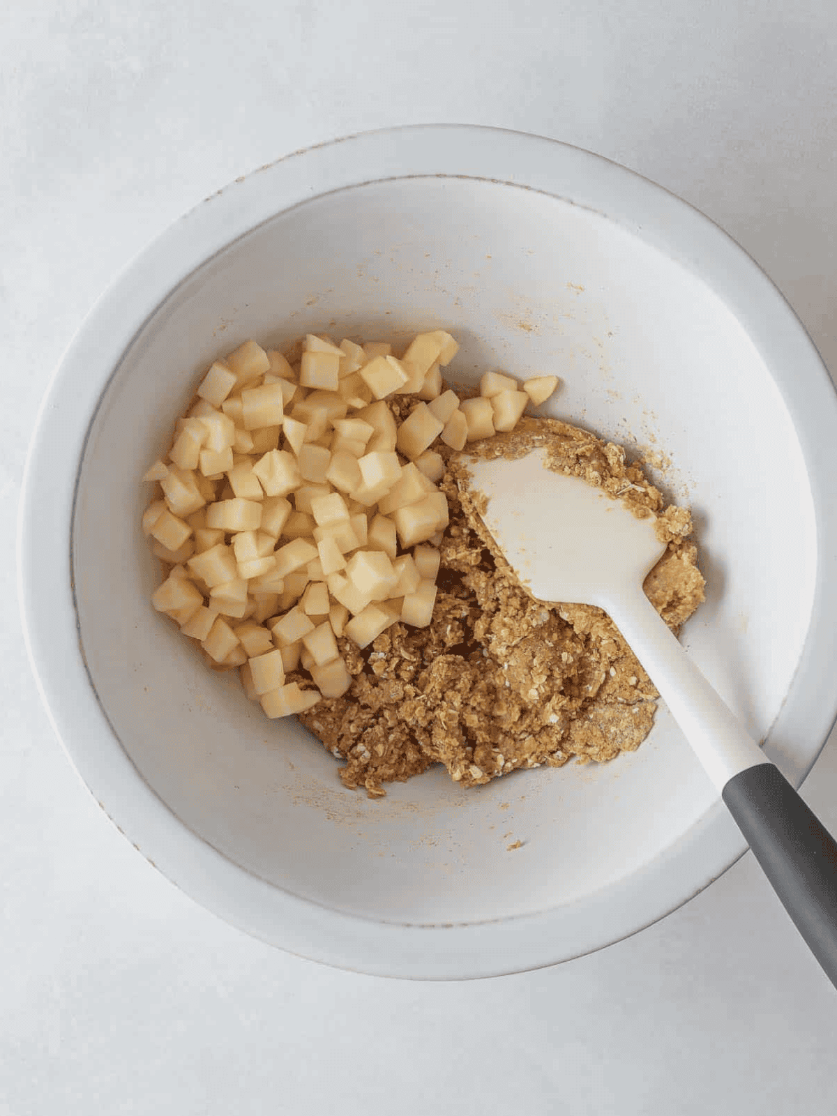 Diced apples added to oatmeal cookie dough before mixing.