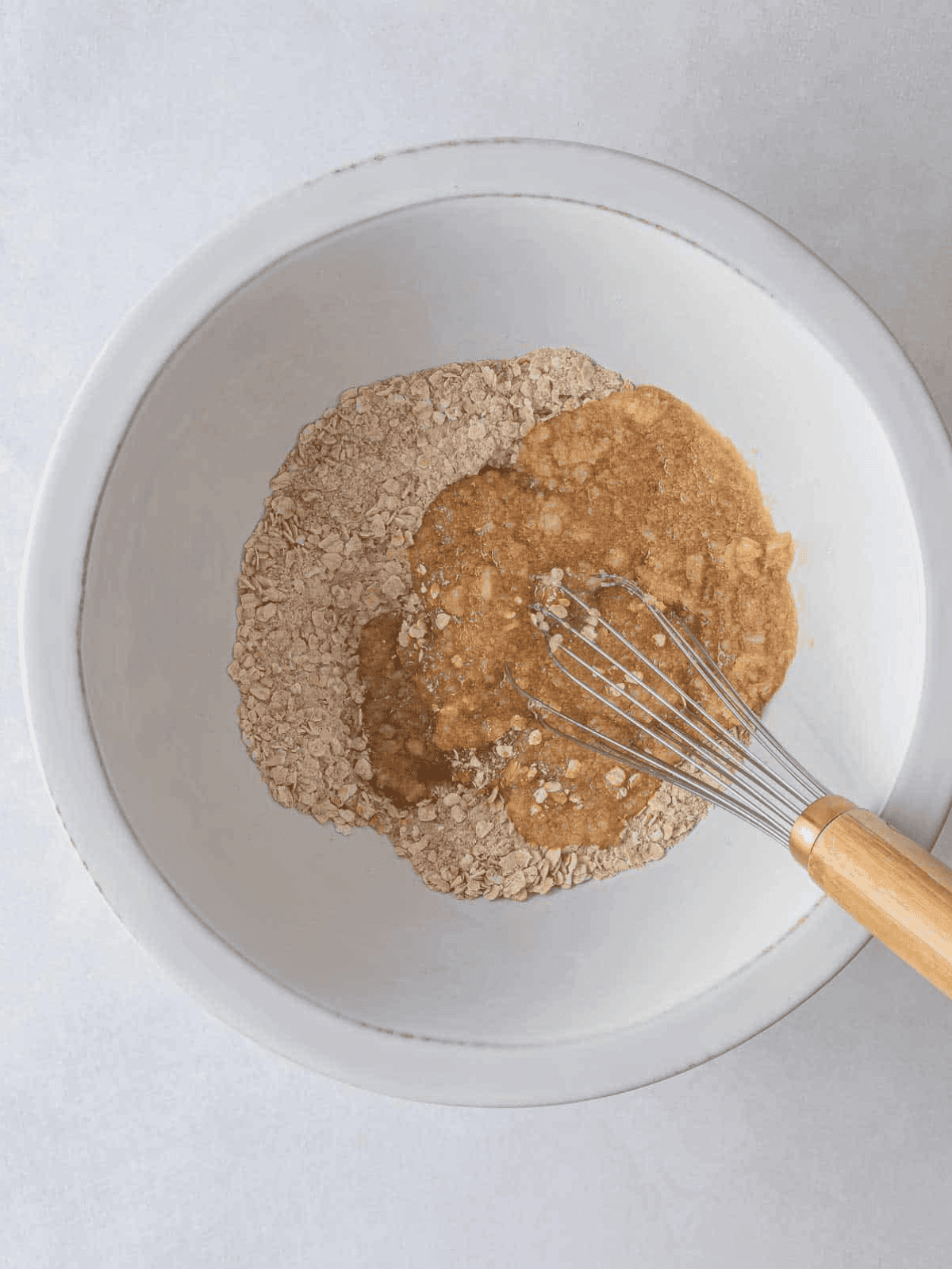 Wet ingredients poured over the oat and flour mixture.