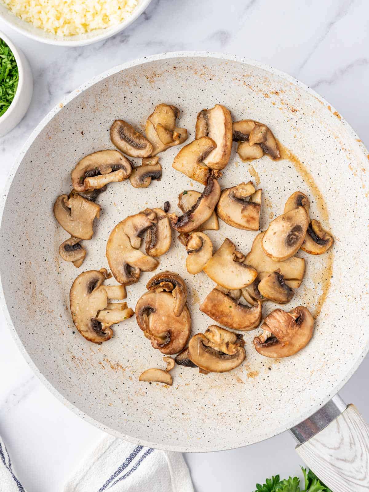 Cooked mushrooms in a skillet.