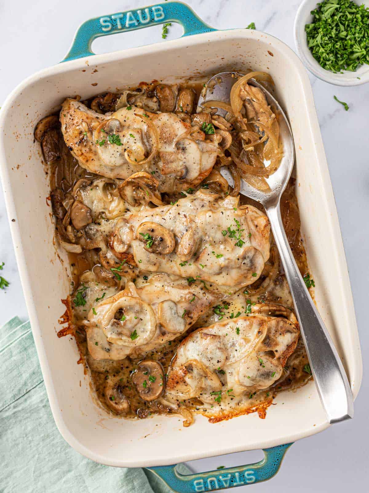 baked mushroom chicken in a dish with a spoon 