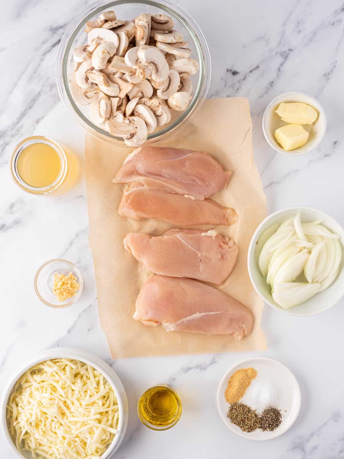 Ingredients needed for cheesy baked chicken breasts with mushrooms.