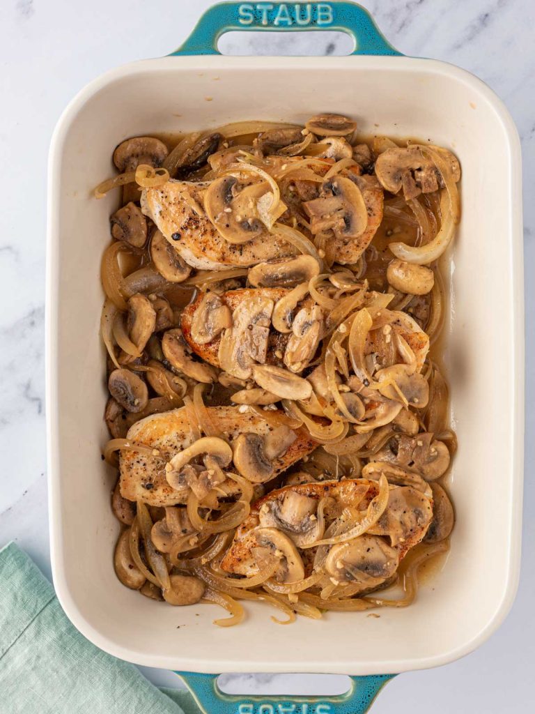 Mushrooms added on top of chicken breasts.
