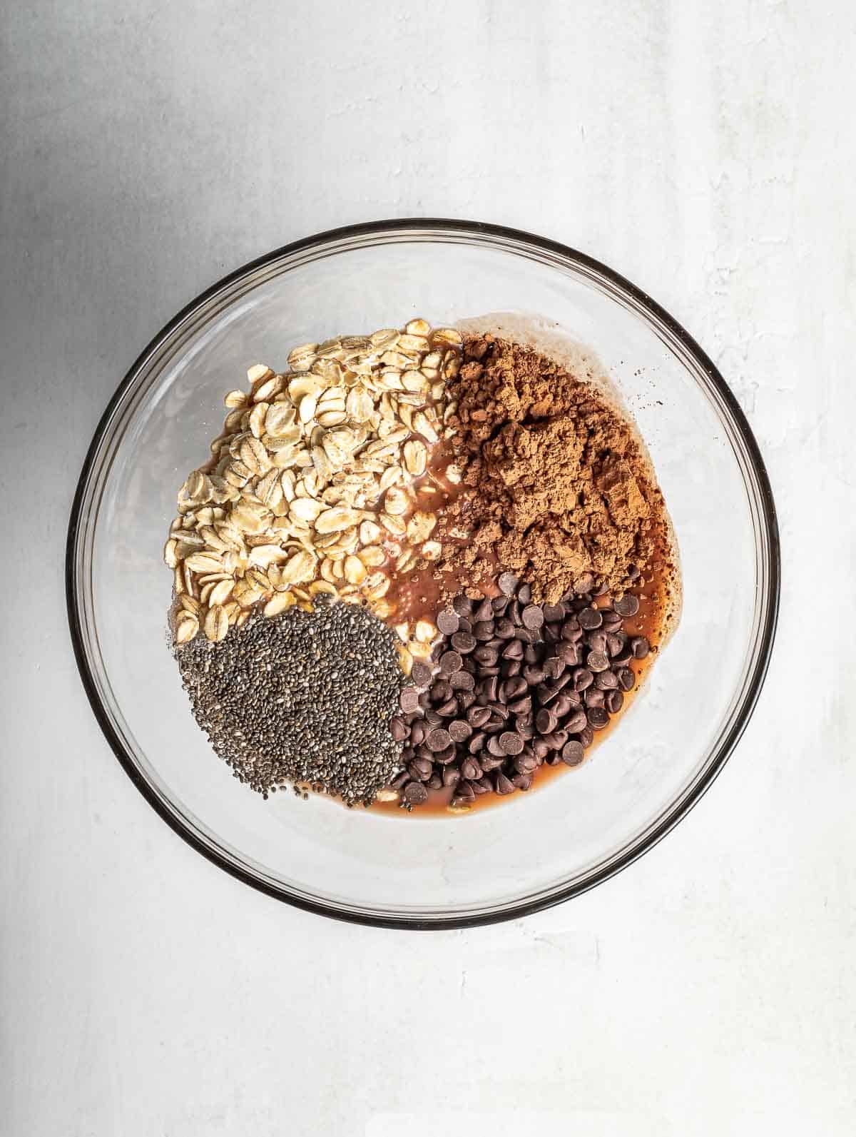 ingredients of chocolate overnight oats in a bowl before mixing