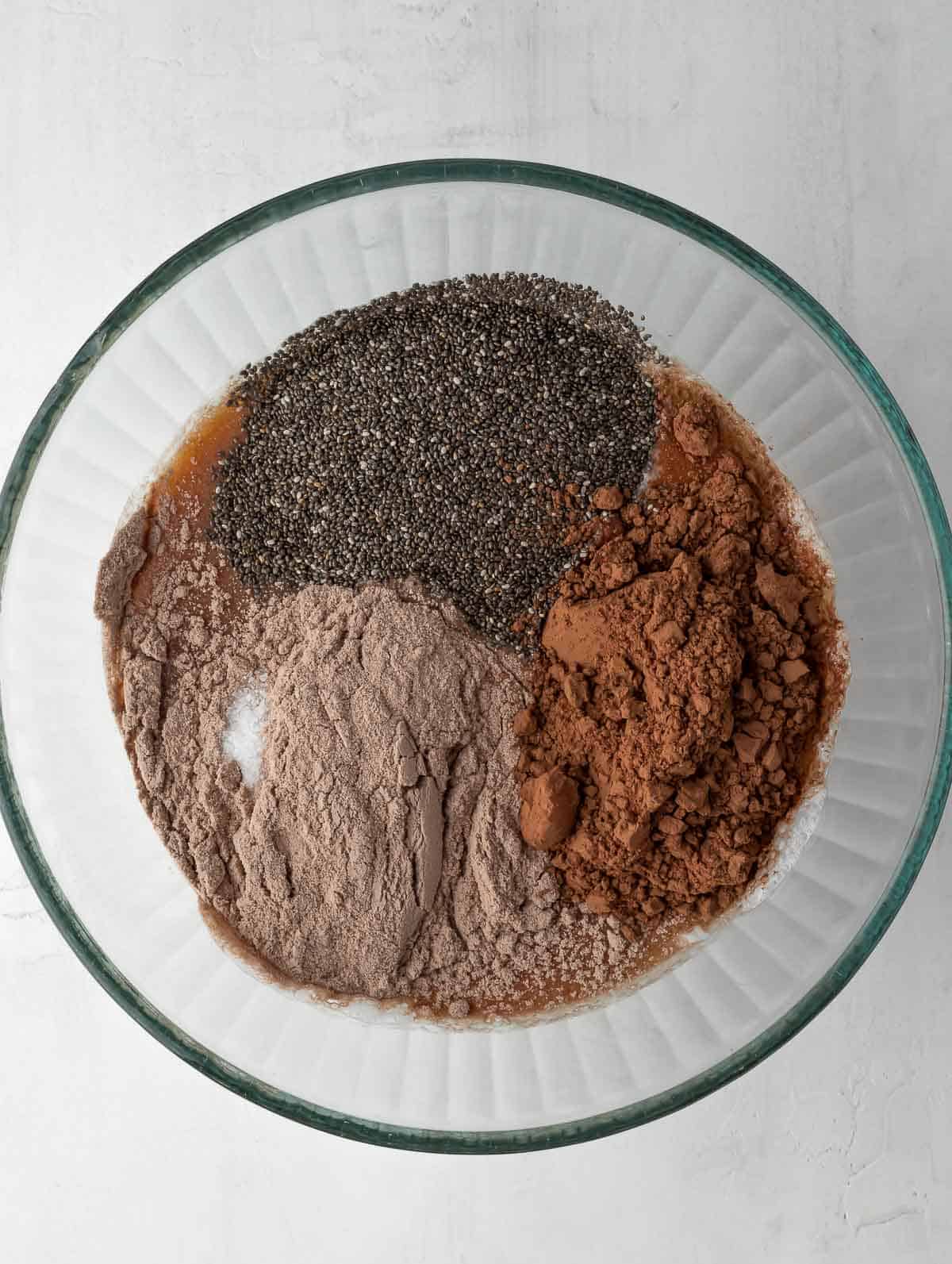 ingredients of chocolate protein chia pudding in bowl before mixing