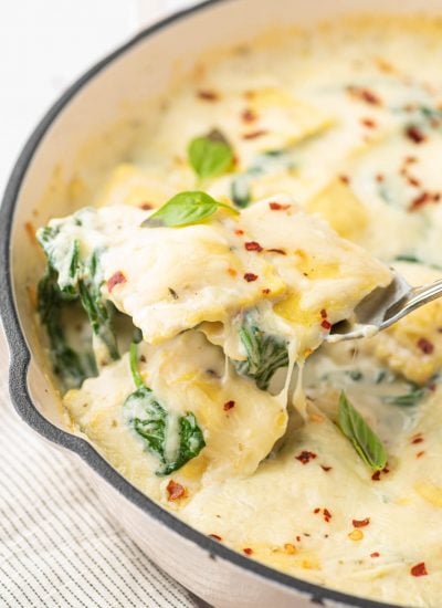 Cheese and Spinach Ravioli Recipe with a scoop being served.