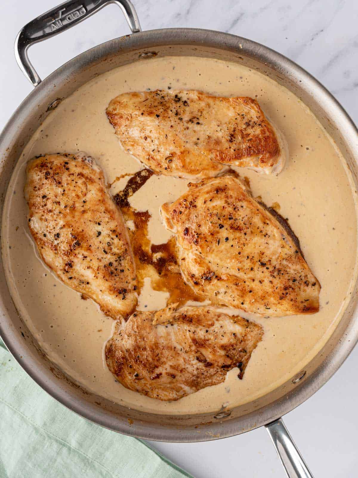 Chicken added to pan of sauce.