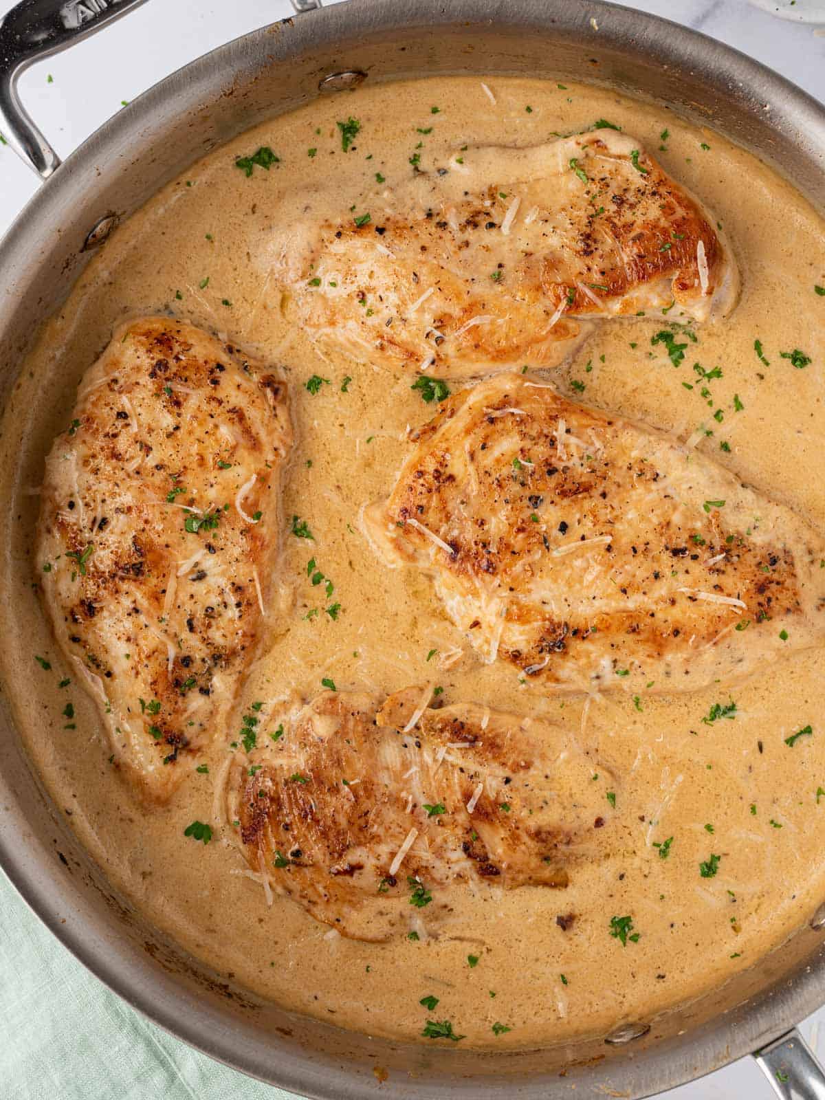 A pan of creamy garlic parmesan chicken breasts.