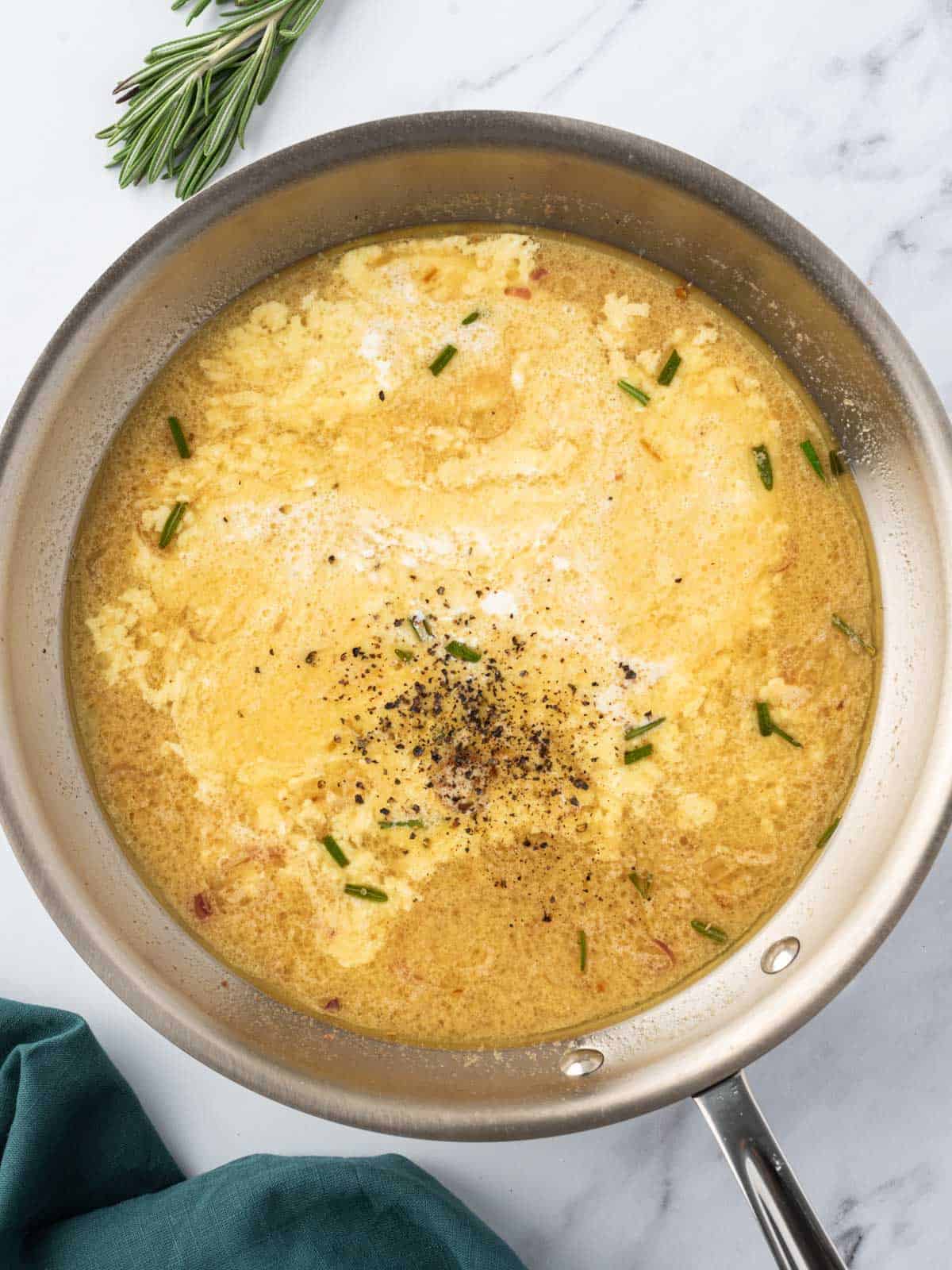 Heavy cream added to the pan.