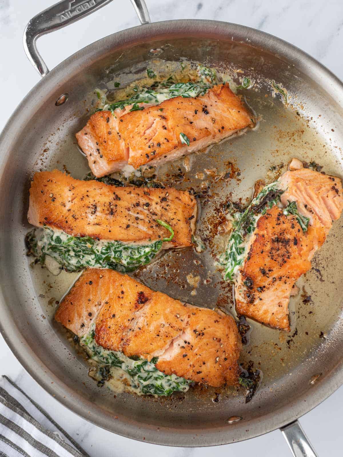 Stuffed salmon pan seared in a pan.