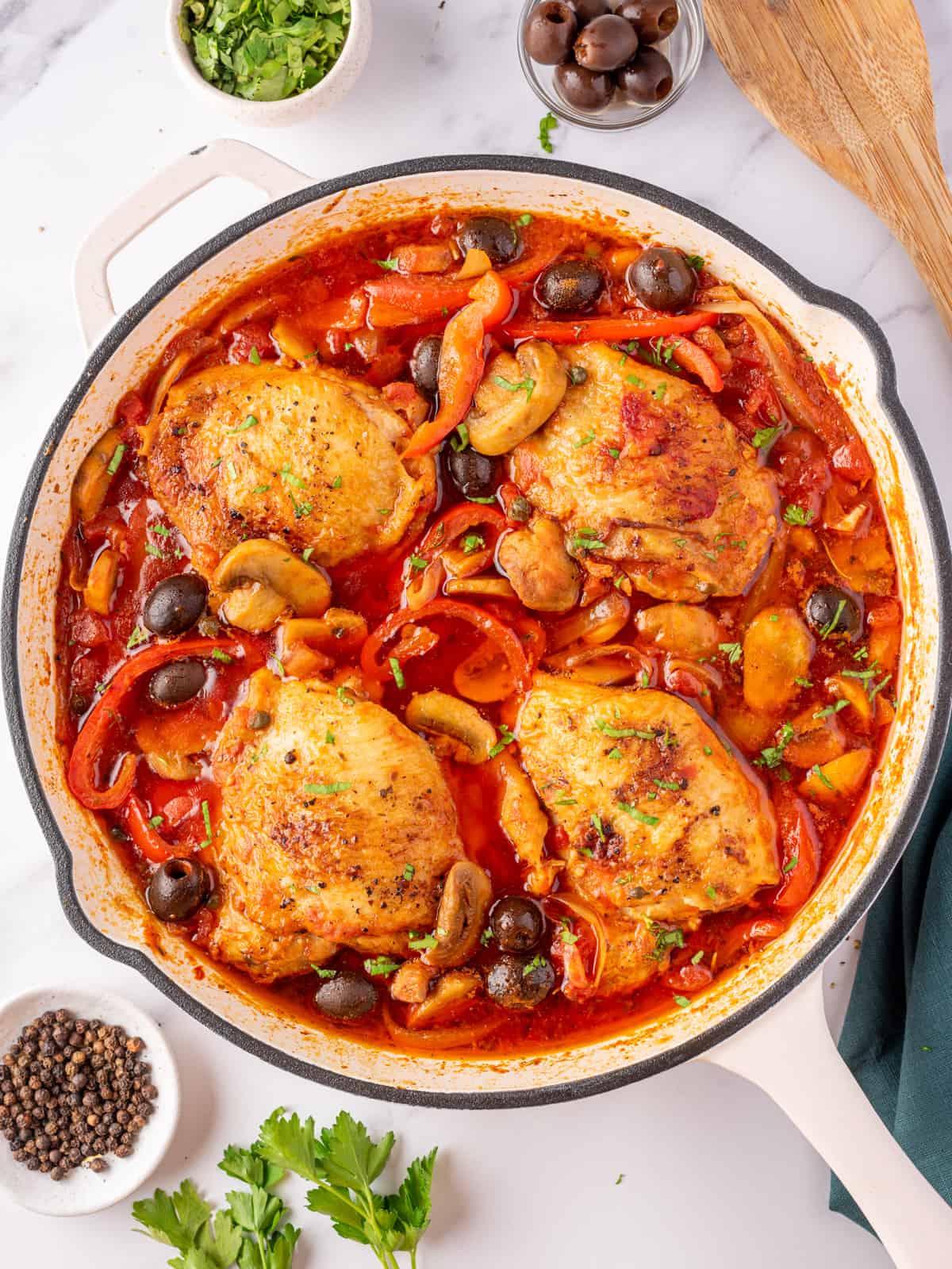The best chicken cacciatore with chicken thighs, red peppers and olives.