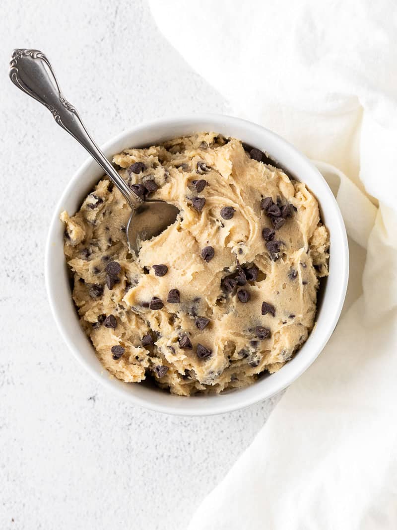 edible cookie dough in a white bowl with a spoon