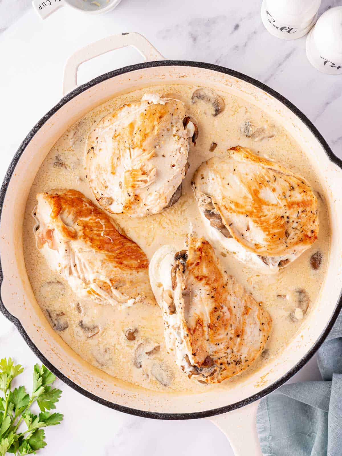 Garlic butter mushroom stuffed chicken in a skillet.