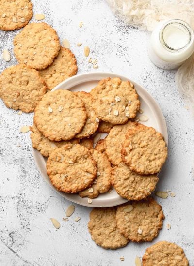 Crispy Almond Cookie on a plate with a bottle of milk next to it.