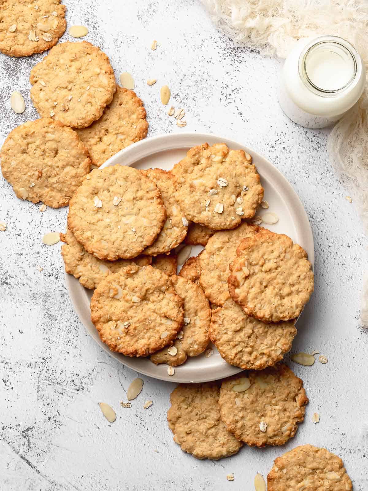 Crispy Almond Cookie on a plate with a bottle of milk next to it.