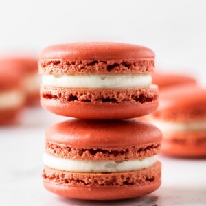 two pieces of red velvet macaron stacked on top of each other