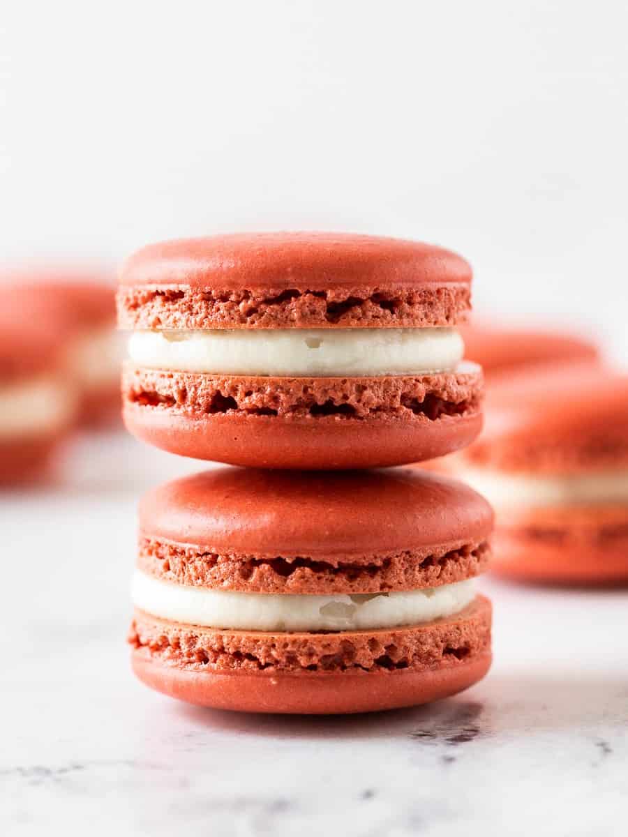 two pieces of red velvet macaron stacked on top of each other