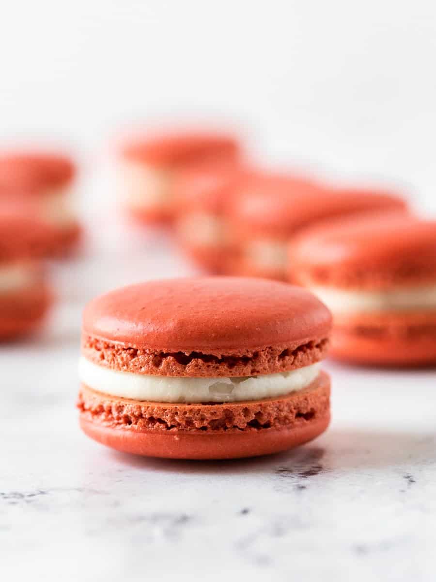 close up shot of one piece of red velvet french macaron