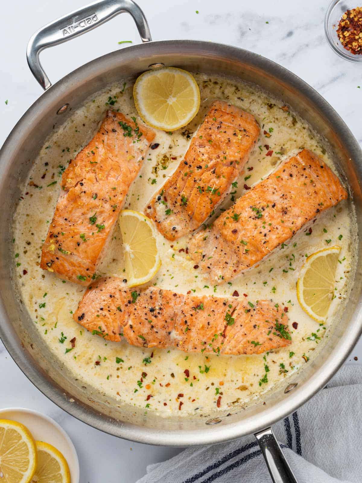 A pan with creamy lemon butter salmon.