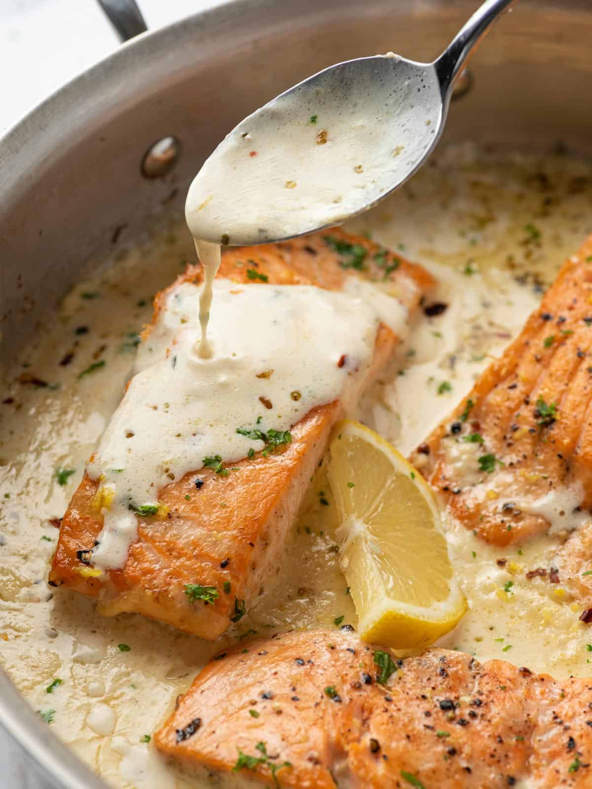 A pan of creamy lemon butter salmon.