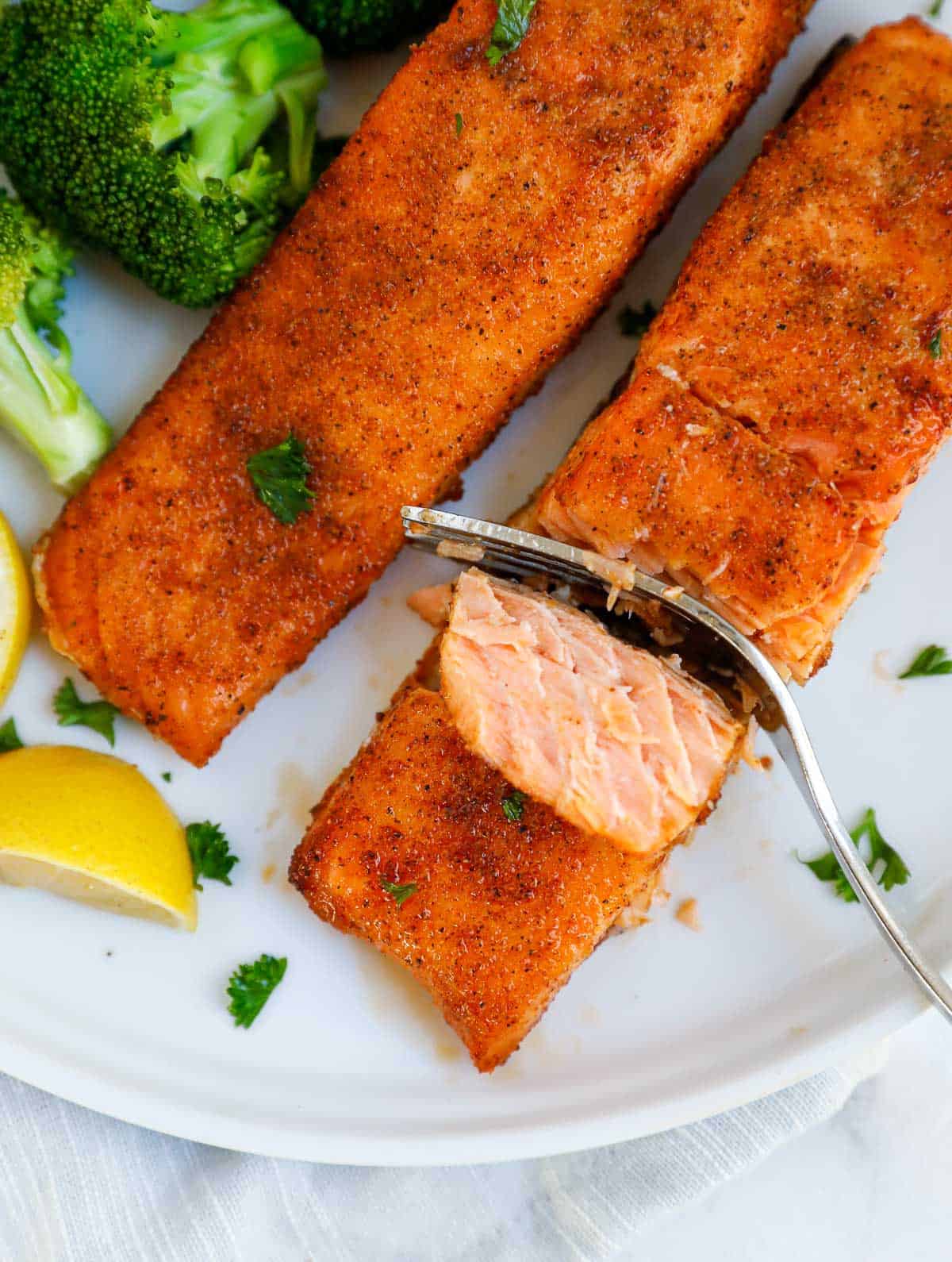 cutting into an air fried salmon