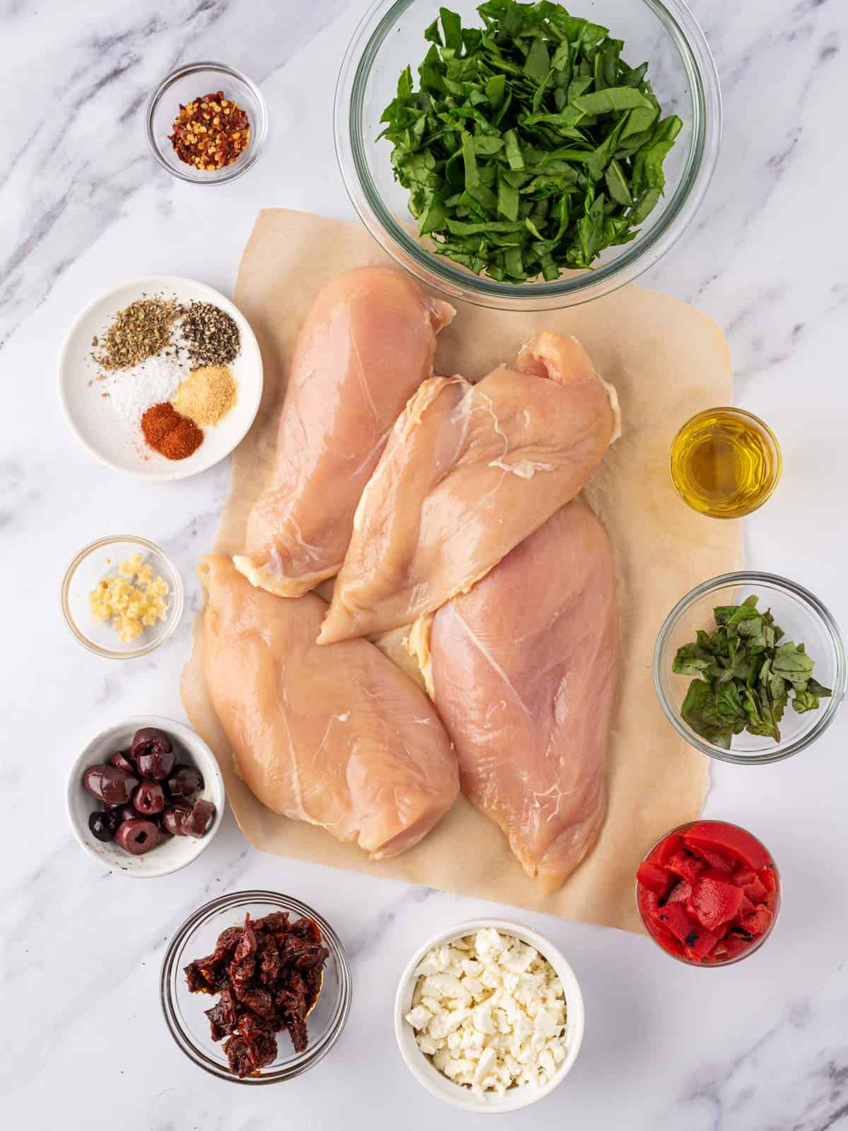 Ingredients needed to make Mediterranean stuffed chicken breasts.