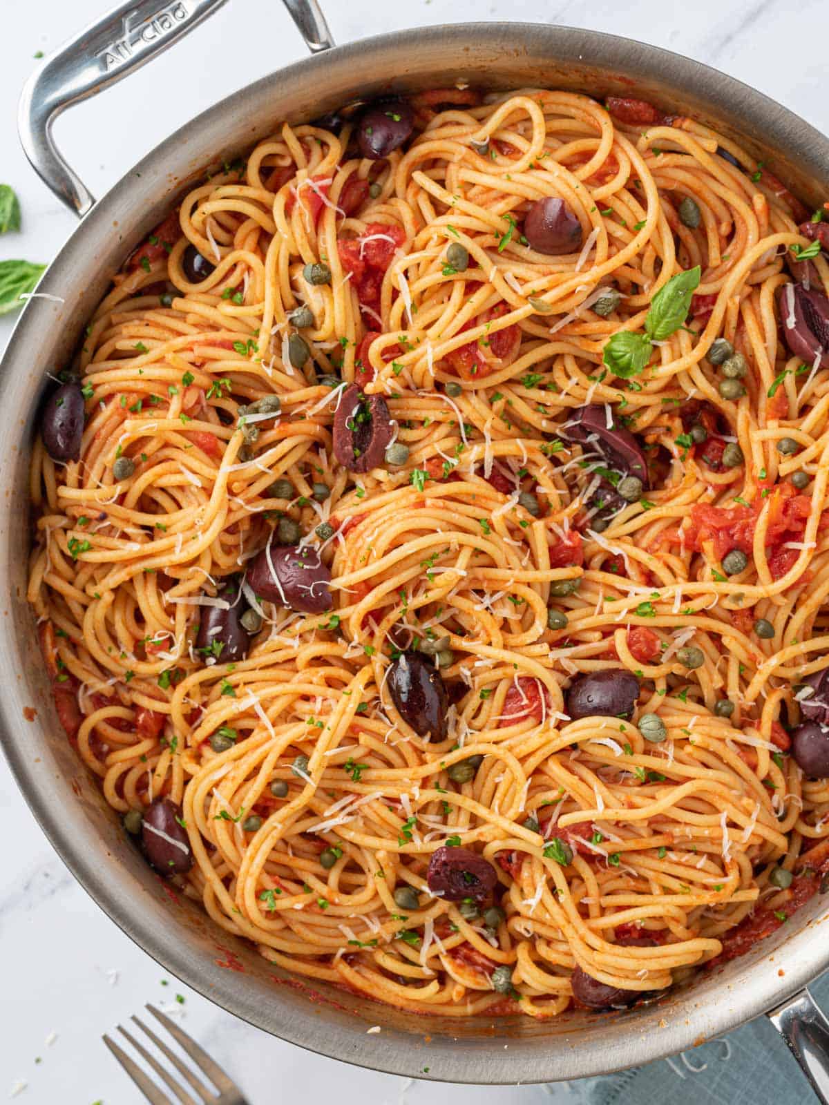 A pan of pasta puttanesca.