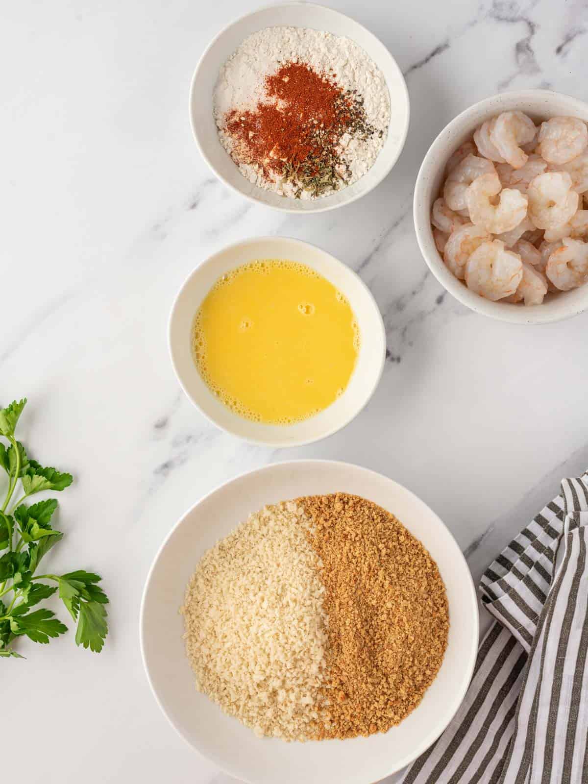 Ingredients needed for breading homemade popcorn shrimp.