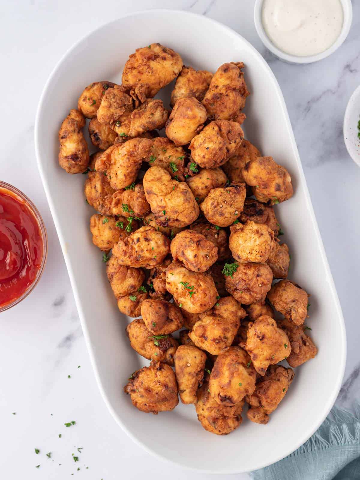 Homemade popcorn chicken on a platter for feeding a crowd.