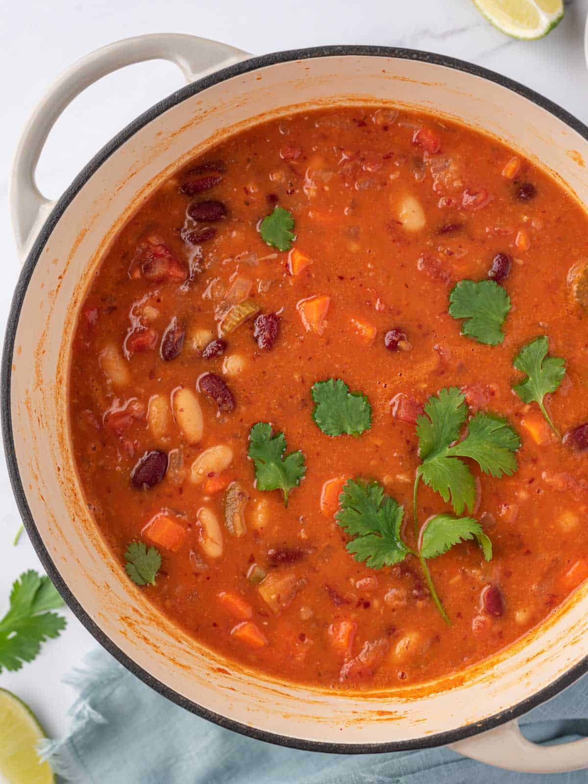 A pot of stovetop chili with cilantro.