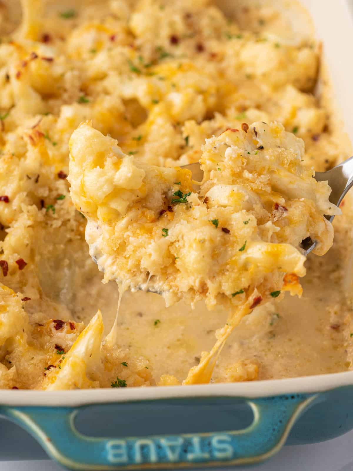 A scoop of cheese cauliflower mac and cheese.