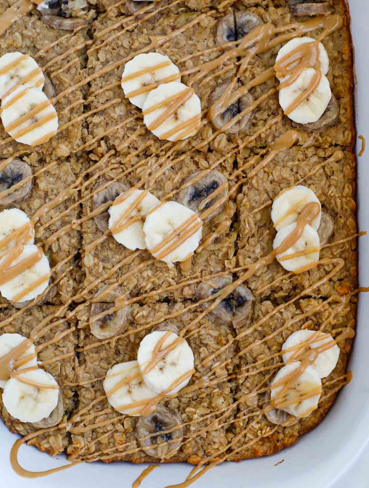 Banana Peanut Butter Baked Oatmeal sliced in a serving dish.