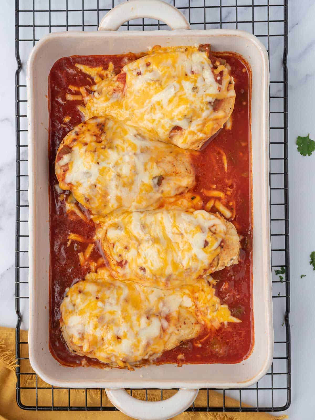 Baked salsa chicken on a wire rack.