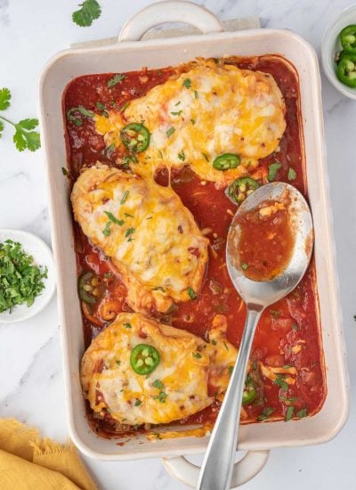A baking dish with baked salsa chicken.