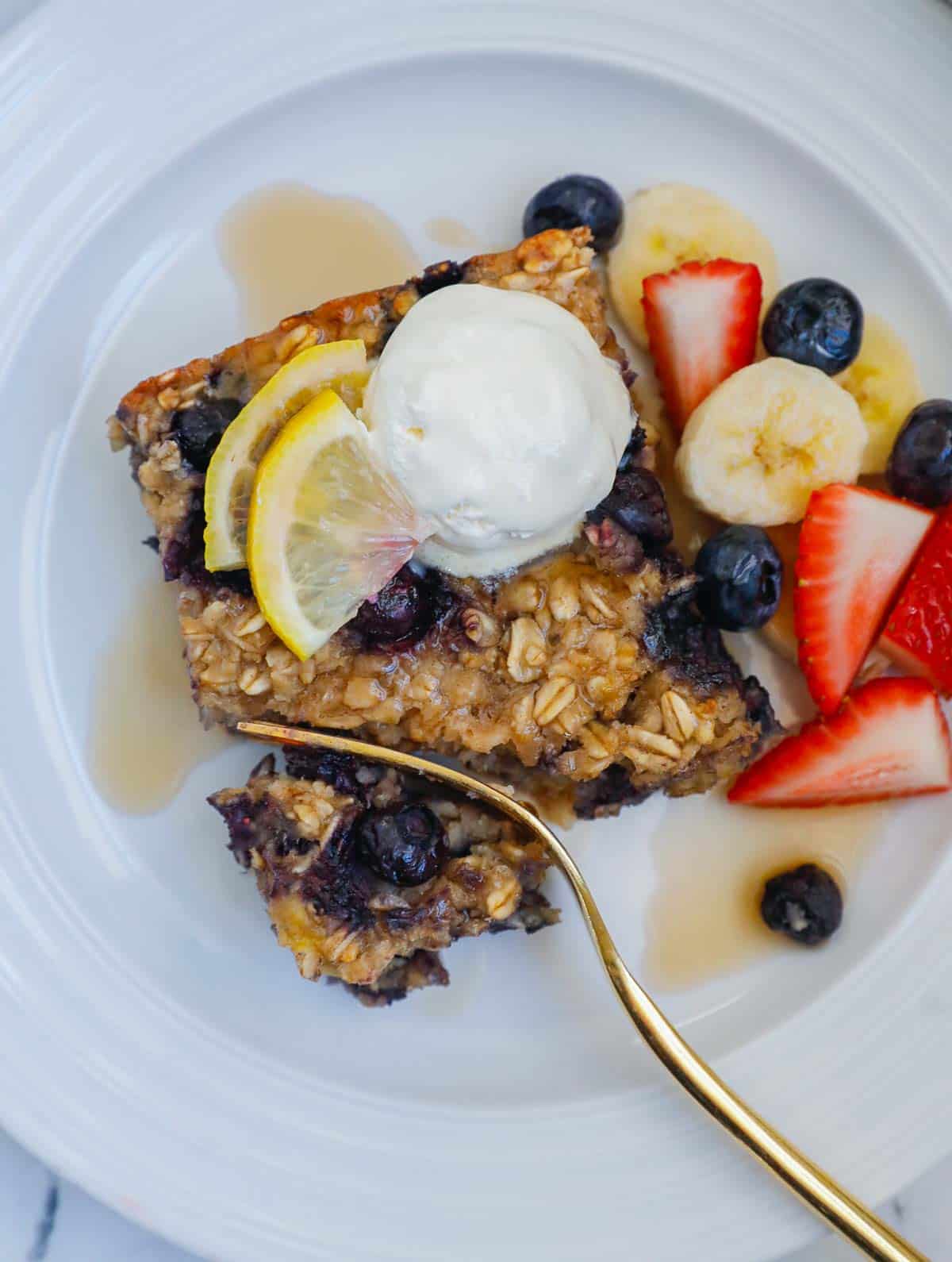 Fork cutting through a piece of blueberry oatmeal bake
