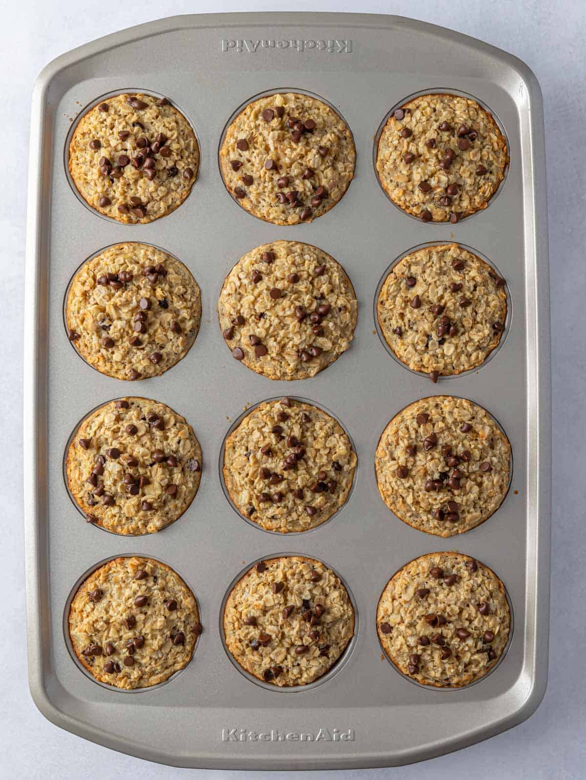 A muffin tin with baked banana oatmeal cups.