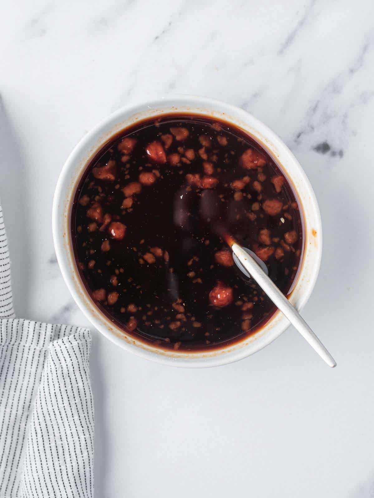 A bowl of honey garlic sauce for sesame chicken.