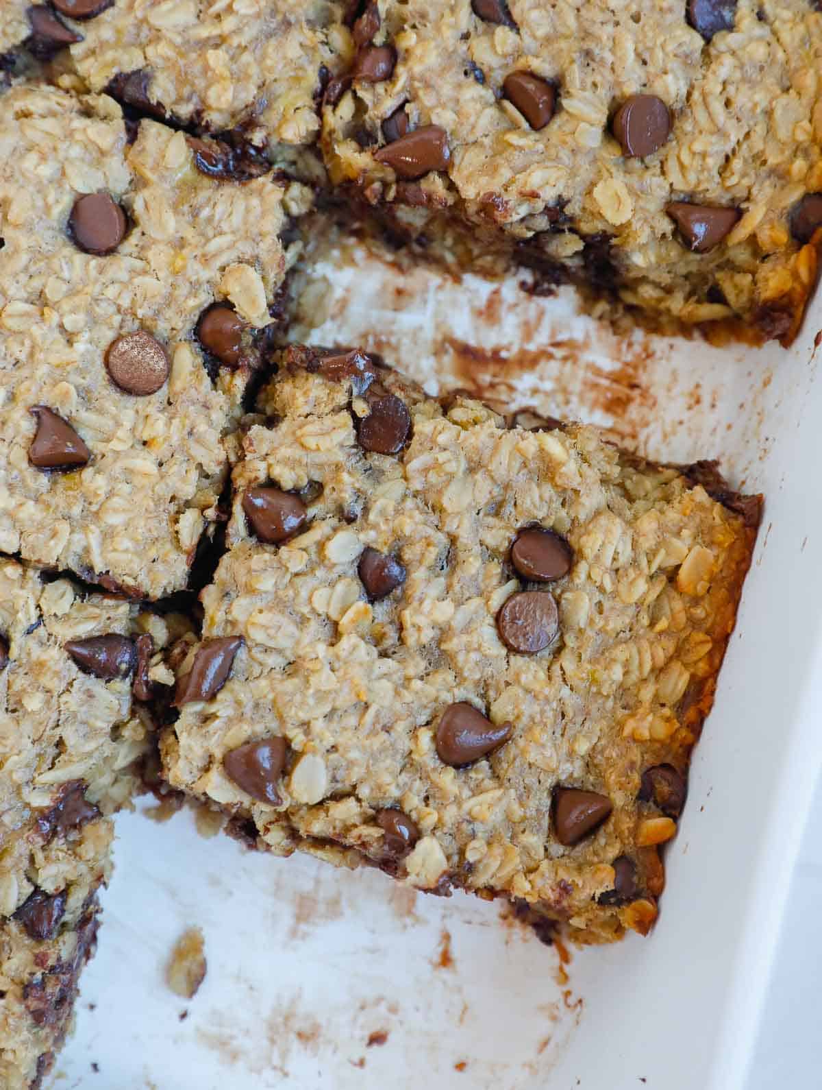 squares of baked chocolate chip oatmeal in a baking dish. 