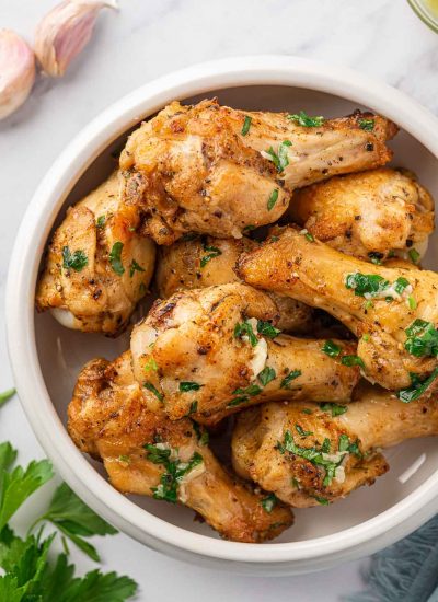 Garlic butter chicken wings in a serving bowl.