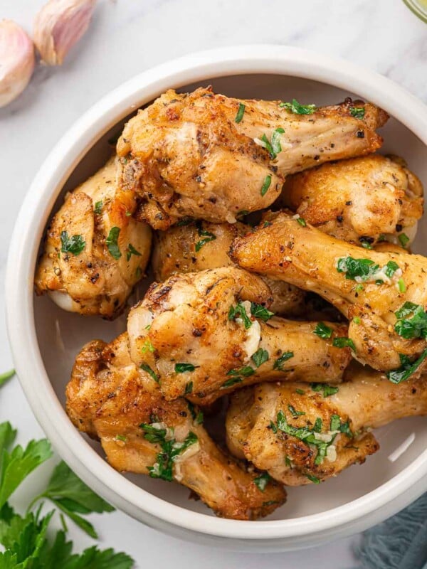 Garlic butter chicken wings in a serving bowl.
