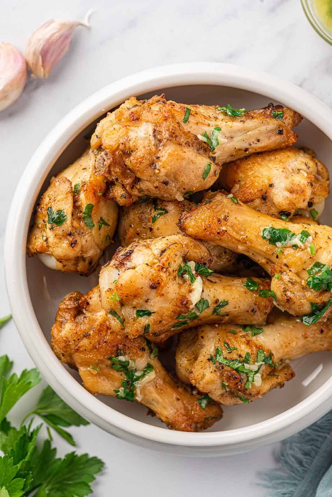 Garlic butter chicken wings in a serving bowl.
