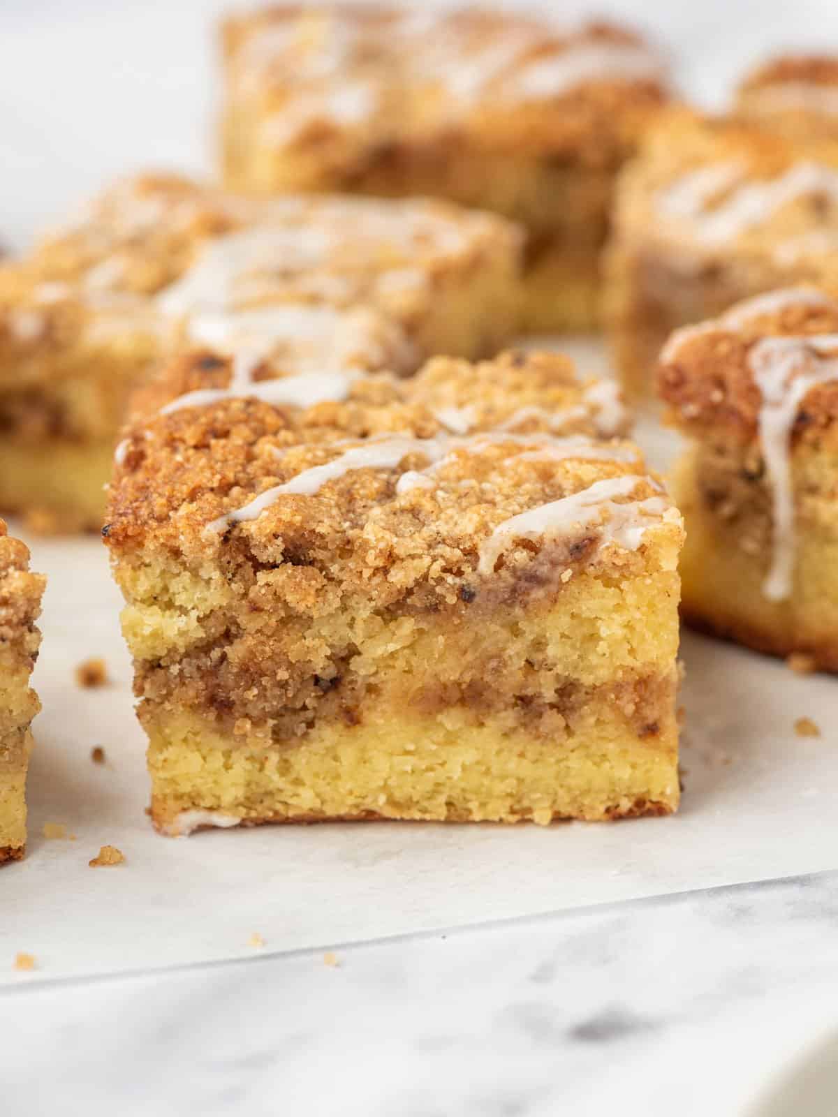 Squares of keto coffee cake on parchment paper.