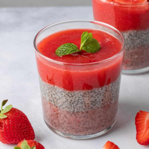 Three-layer chia pudding topped with fresh strawberry puree and mint.